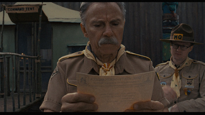 a man in a uniform reading a piece of paper