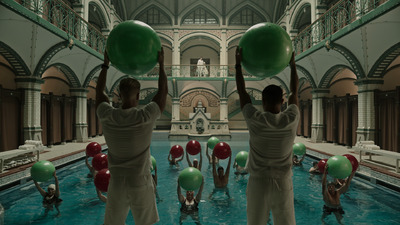 a group of men holding up large green balls