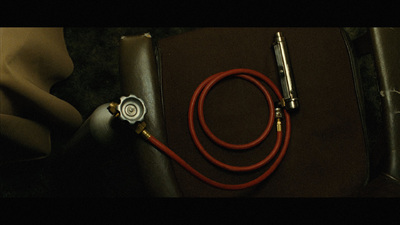 a close up of a red hose on a chair