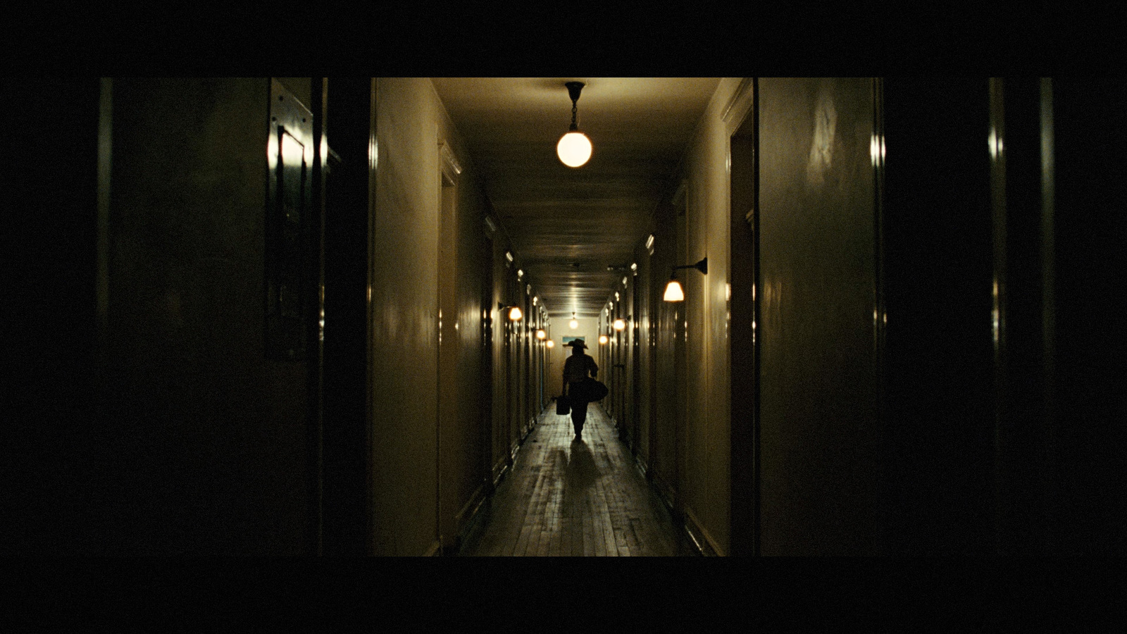 a person walking down a hallway in a building