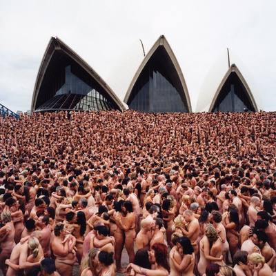 a large group of naked people in front of a building