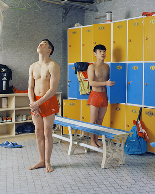 a man standing in front of lockers in a locker room