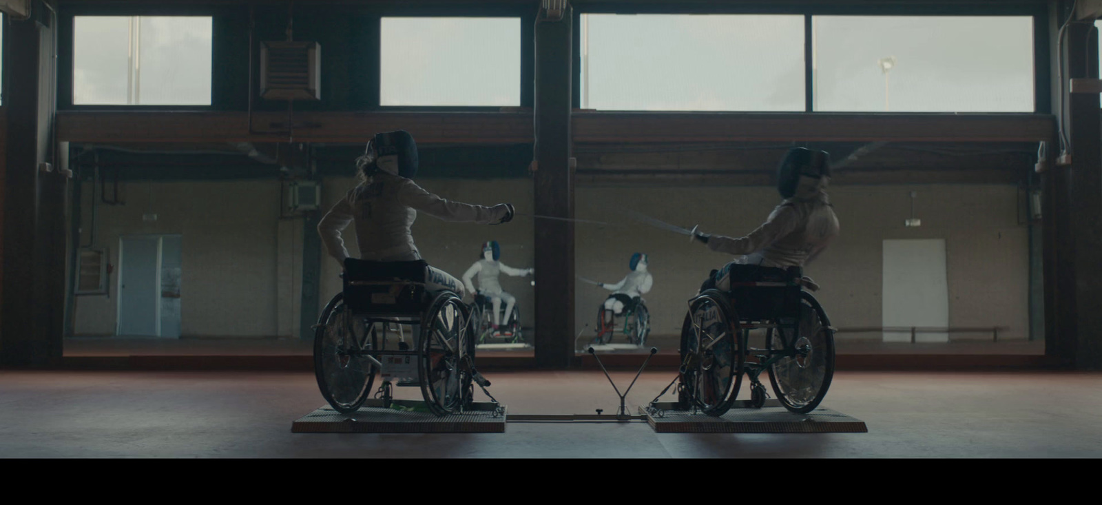 a couple of women riding on the back of bicycles