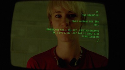 a woman with blonde hair is looking at a screen