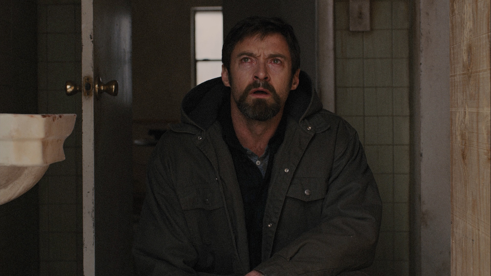 a man standing in a bathroom next to a sink