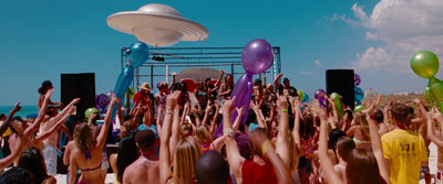 a crowd of people at a beach with balloons