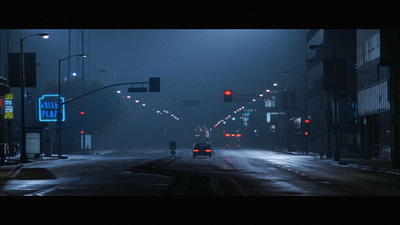 a car driving down a street at night