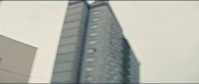 a traffic light in front of a tall building