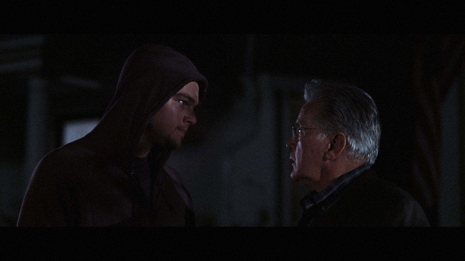 a man in a hoodie talking to another man