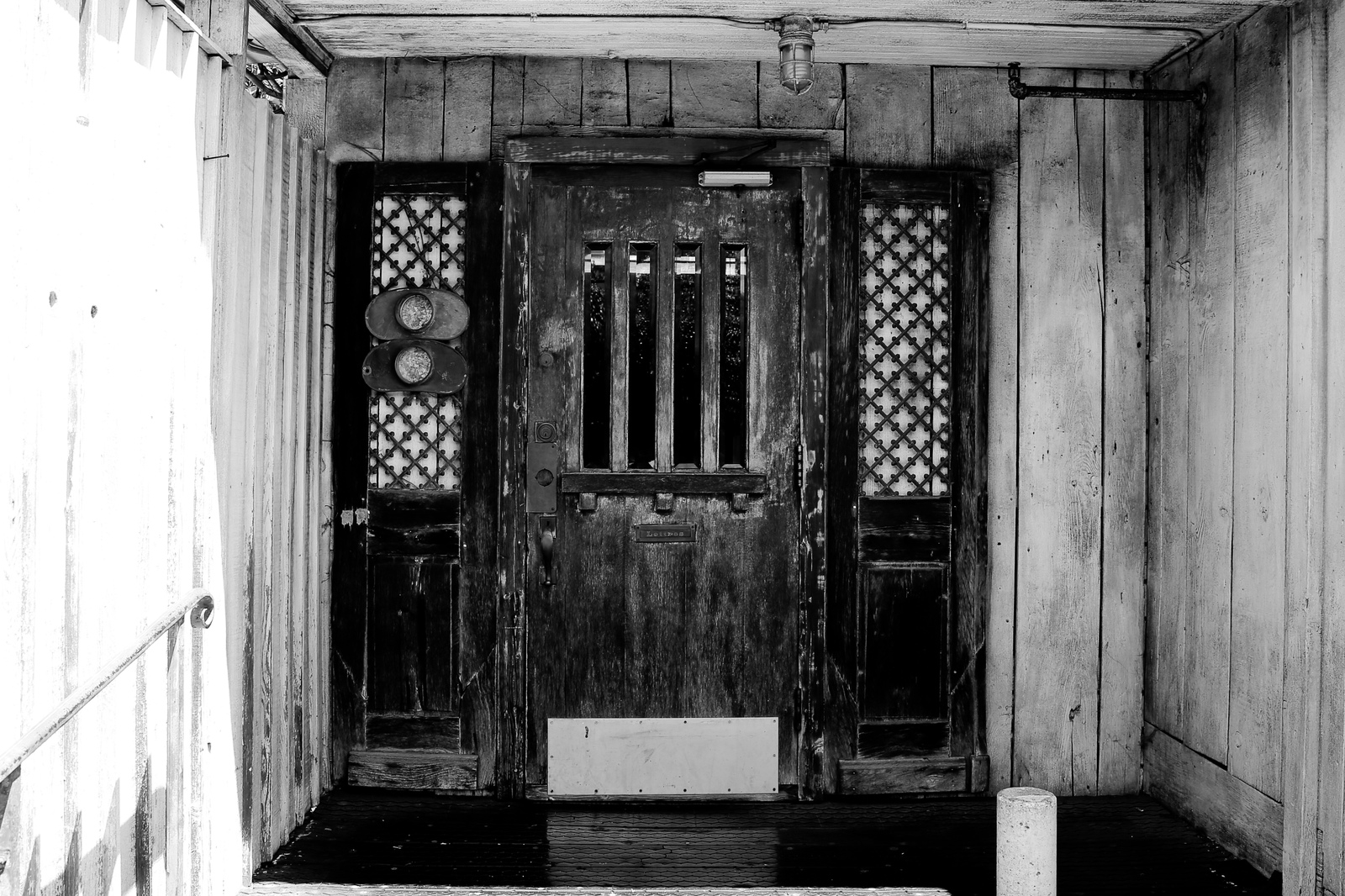 a black and white photo of a wooden door