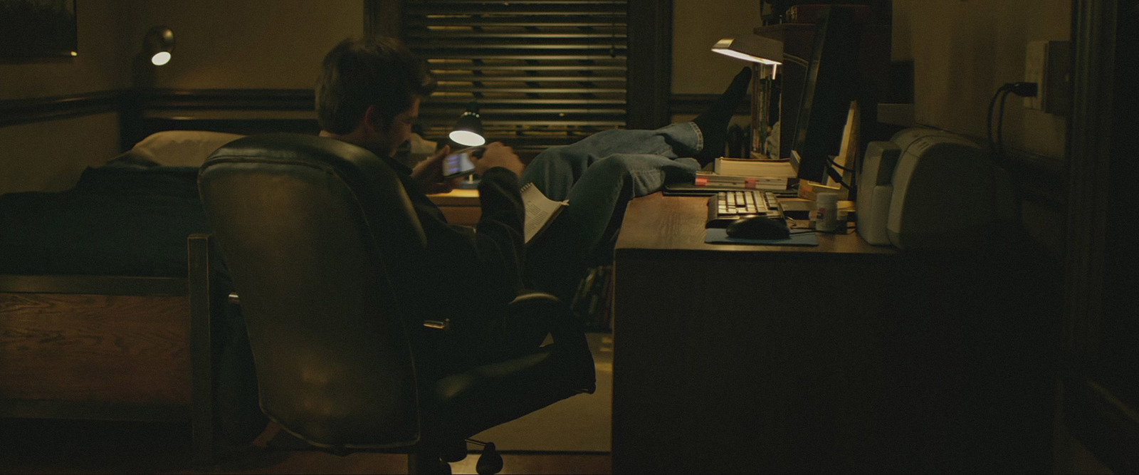 a man sitting at a desk in front of a computer