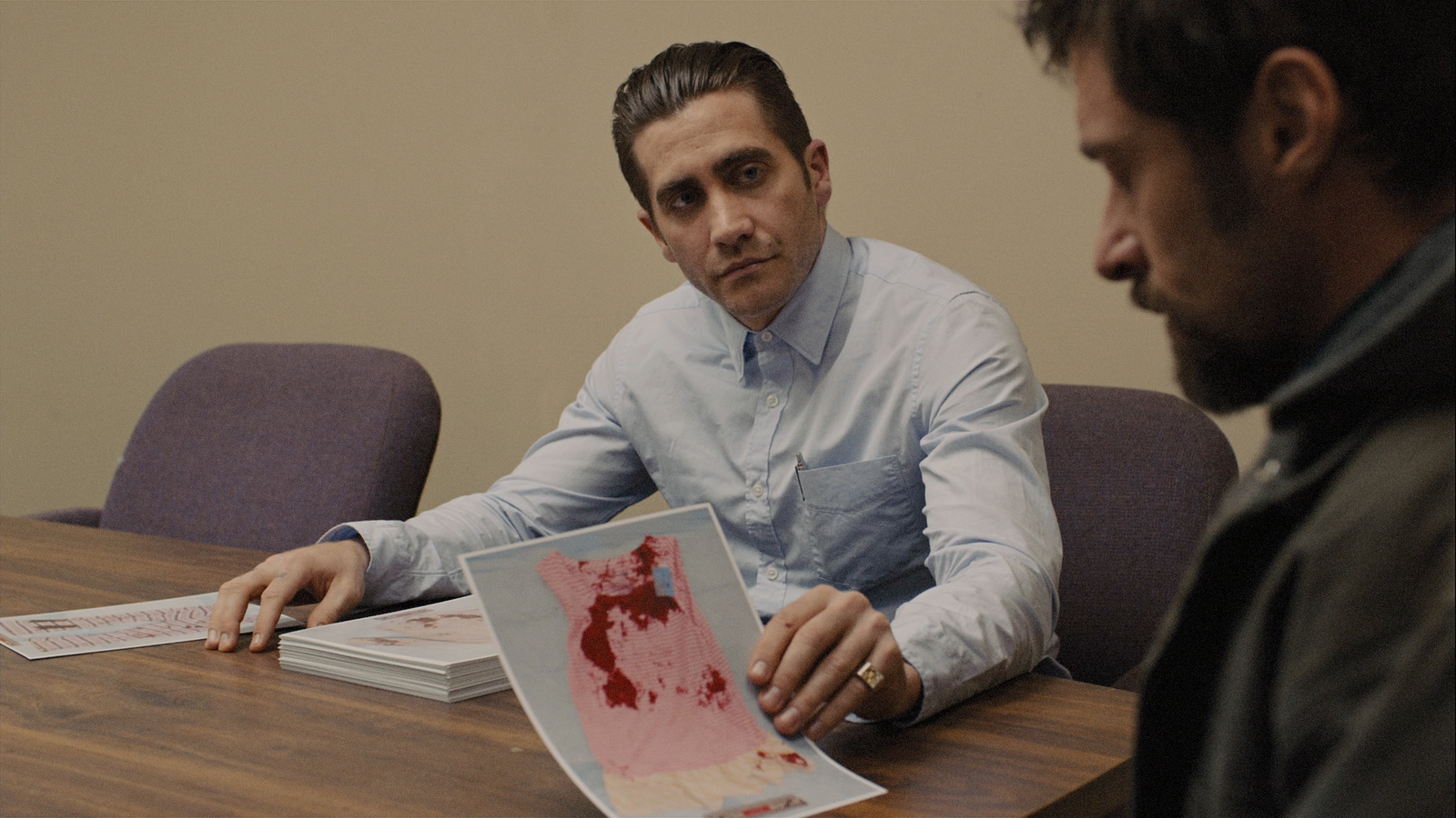 a man sitting at a table with a piece of paper in front of him