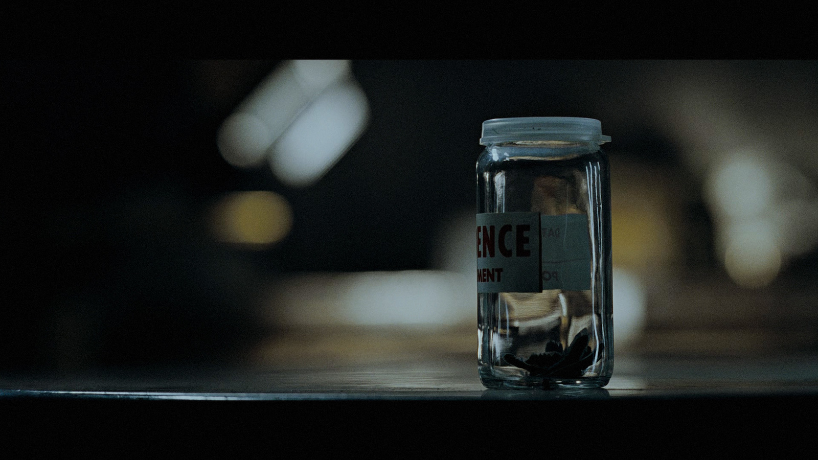 a glass jar with a label on it sitting on a table