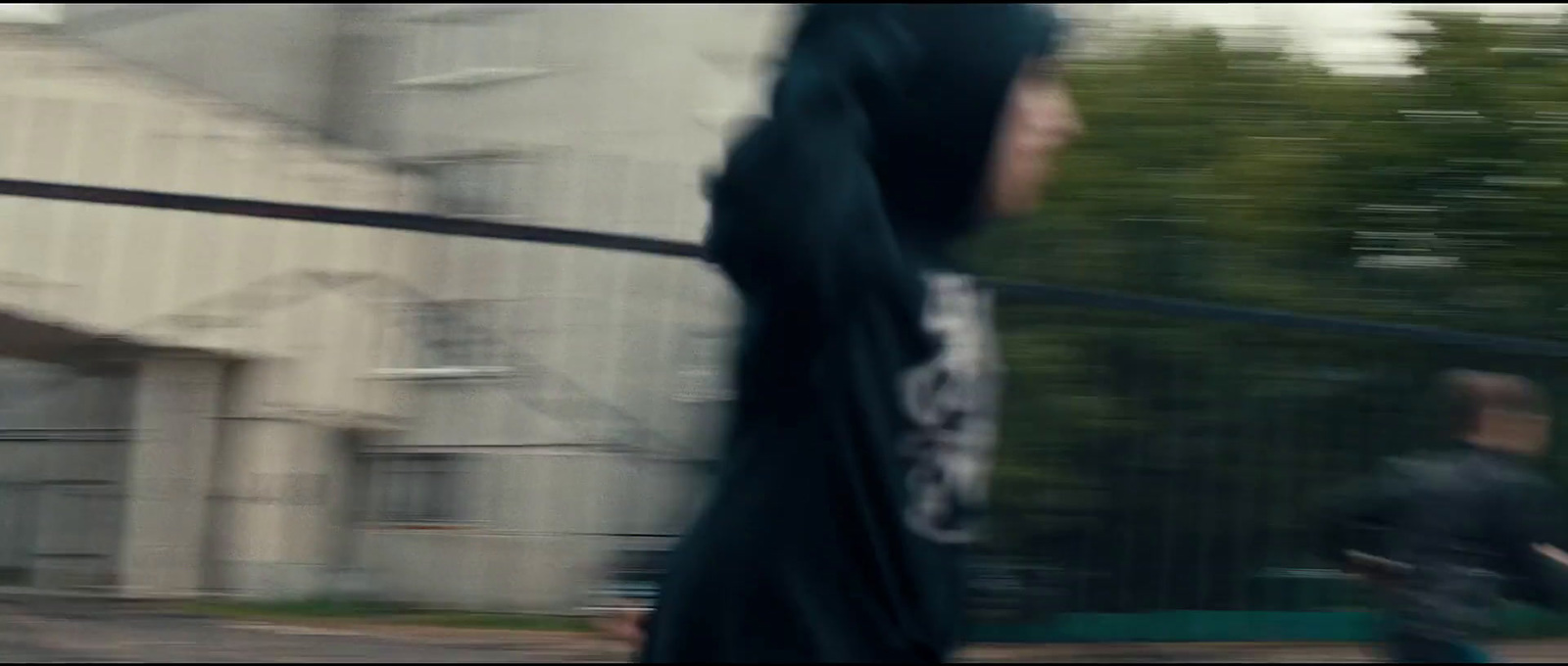 a blurry photo of a man in a hoodie running