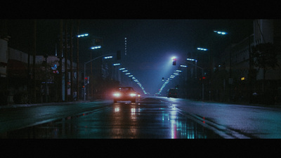 a car driving down a wet street at night