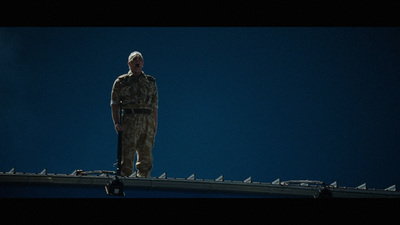 a man standing on top of a metal roof