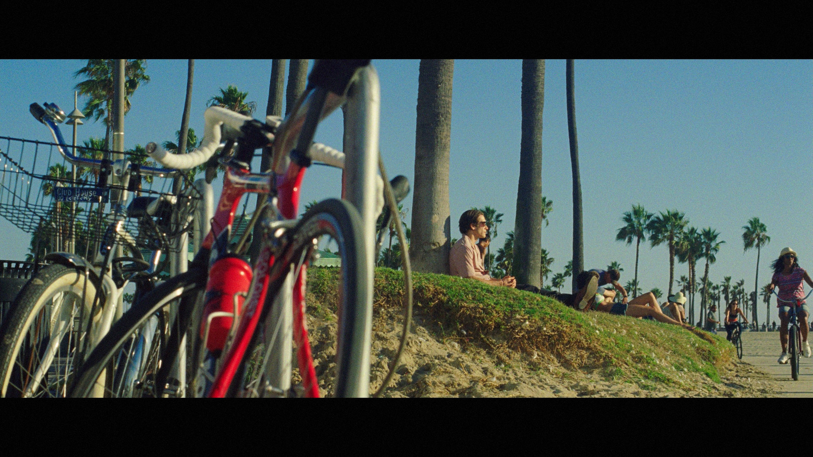 a group of people riding bikes down a sidewalk