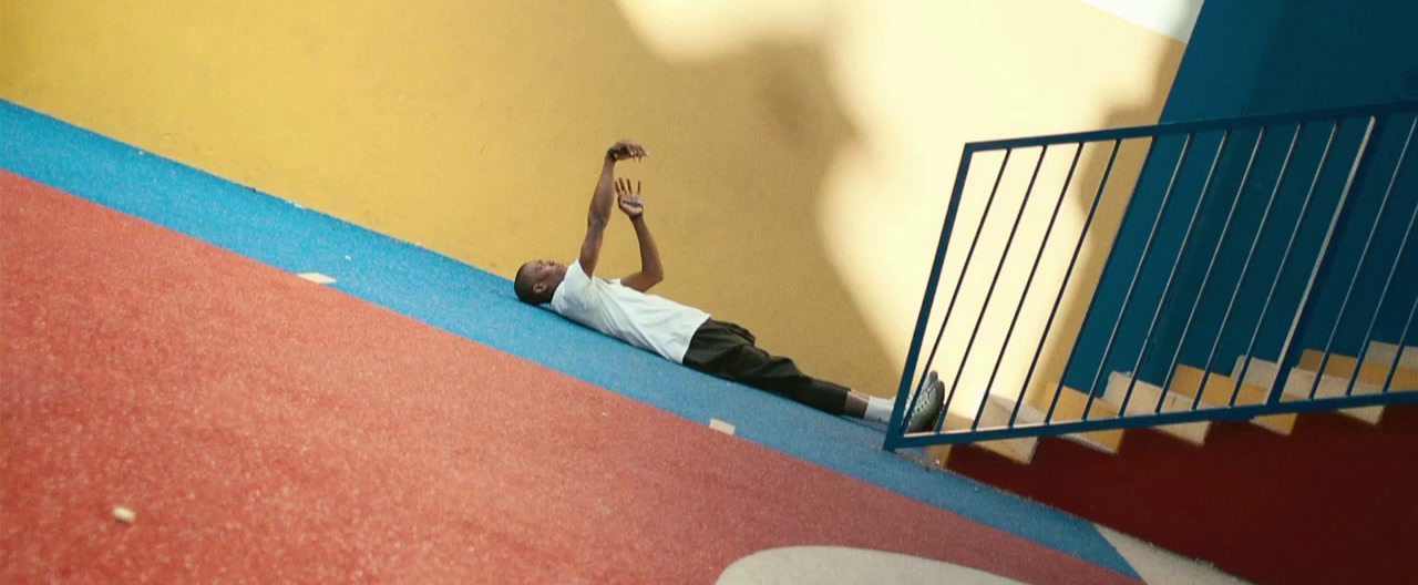 a man laying on the ground next to a stair case