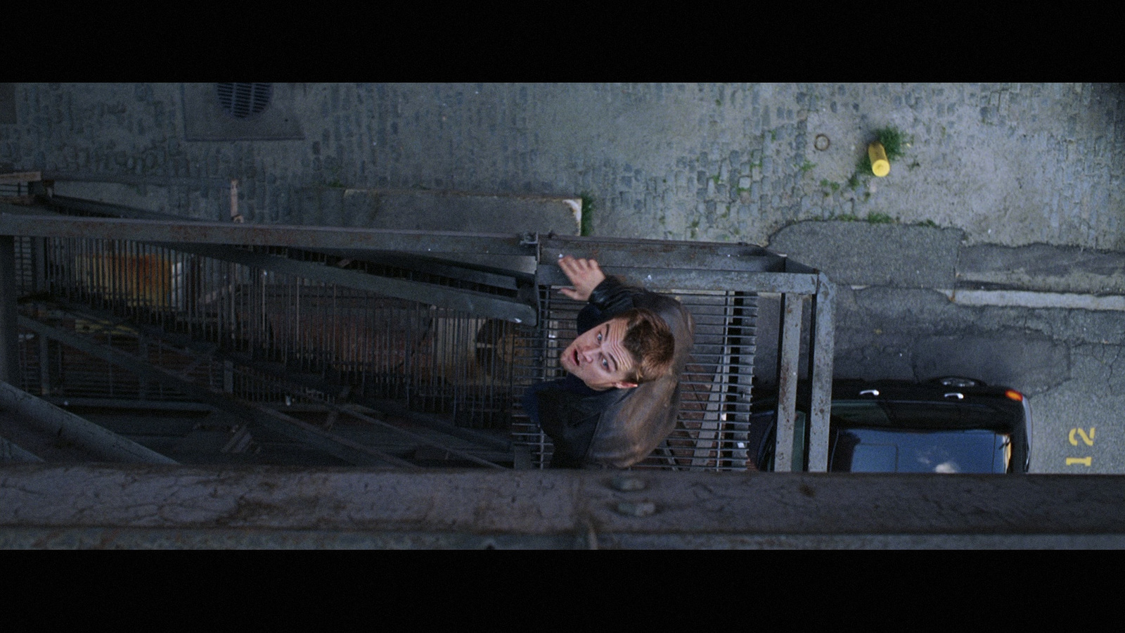 a man standing next to a cage in a building