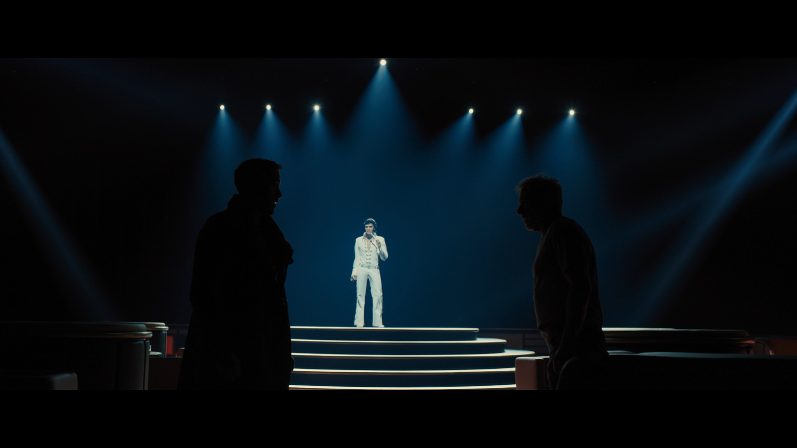 a group of men standing on top of a stage