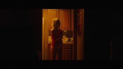 a woman standing in a kitchen at night