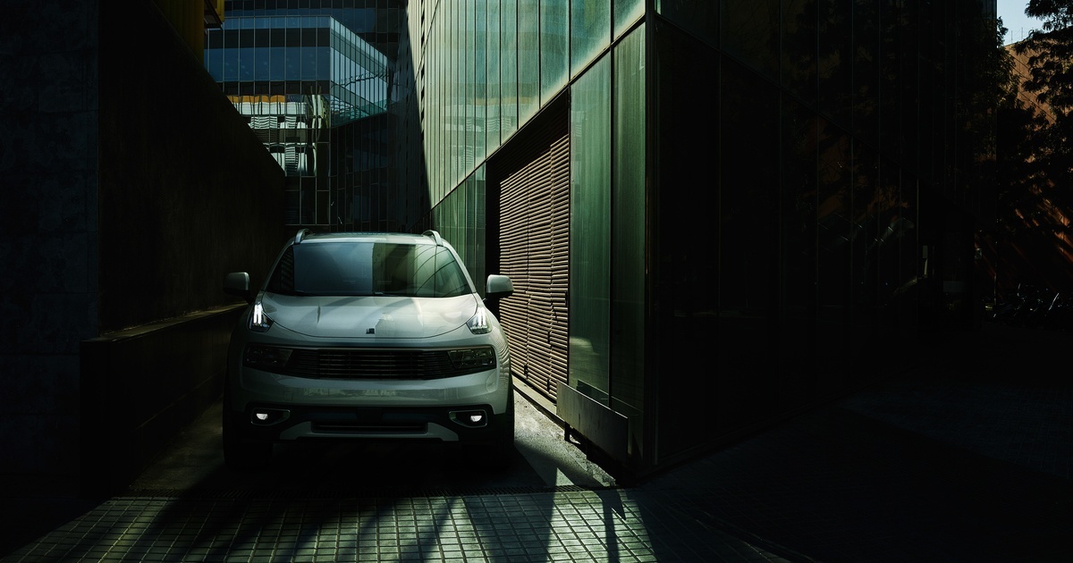 a white car is parked in a narrow alley