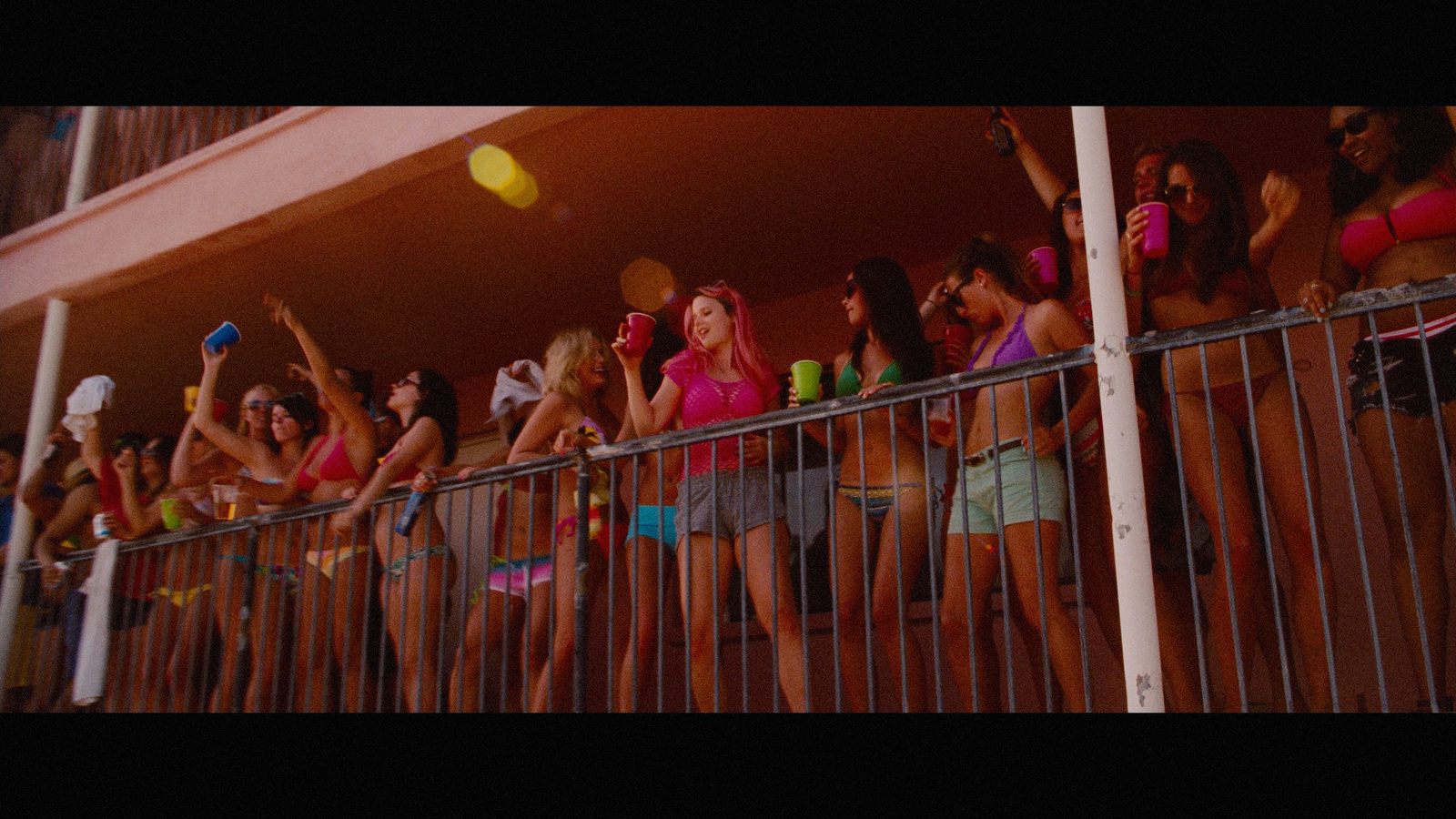 a group of women standing next to each other on a balcony