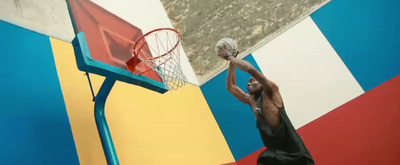 a man dunking a basketball into a hoop