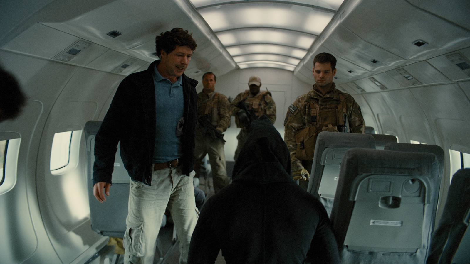 a group of men walking down a hallway next to each other