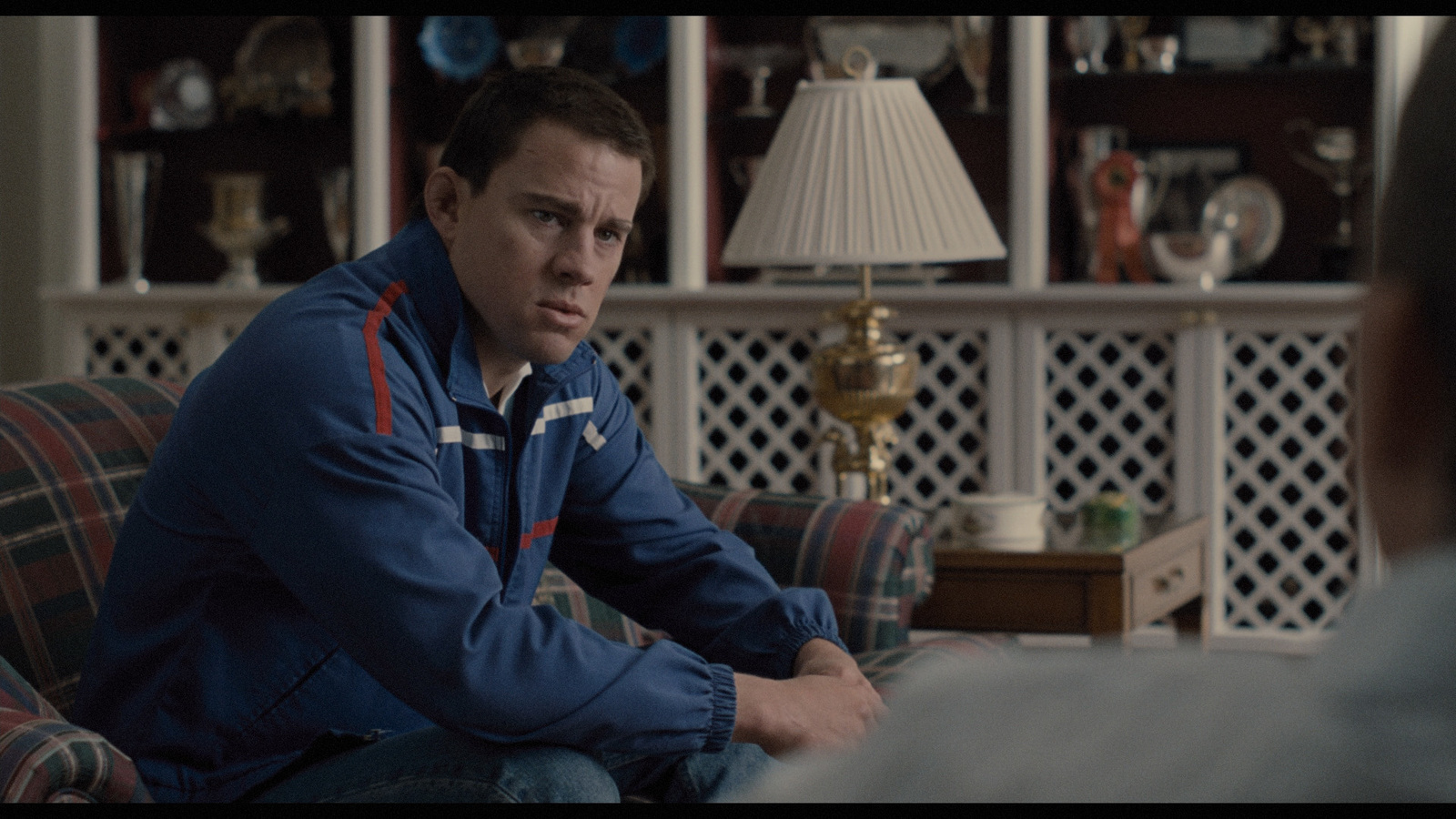 a man sitting on a couch in a living room