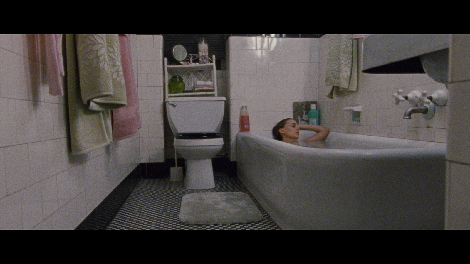 a woman laying in a bathtub in a bathroom