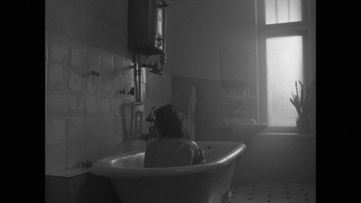 a woman sitting in a bathtub in a bathroom