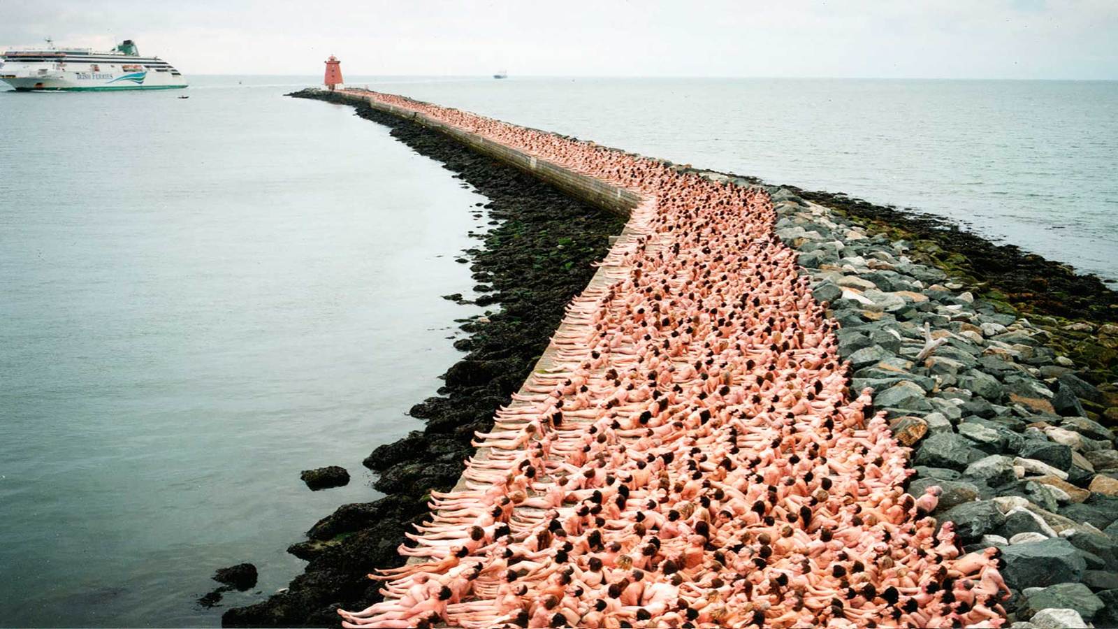 a large group of people laying on top of a pier