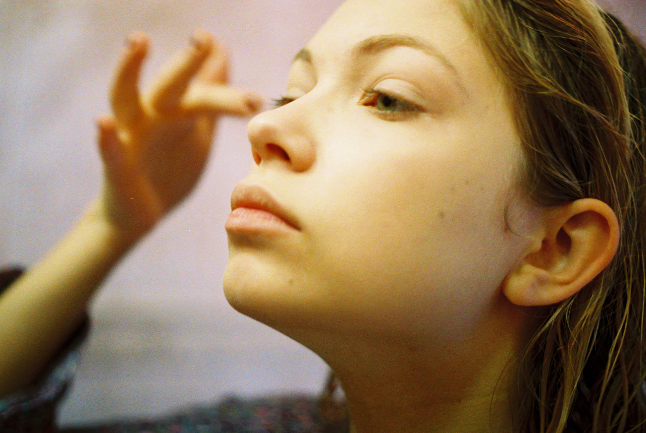 a woman getting her make - up done by a professional make - up artist