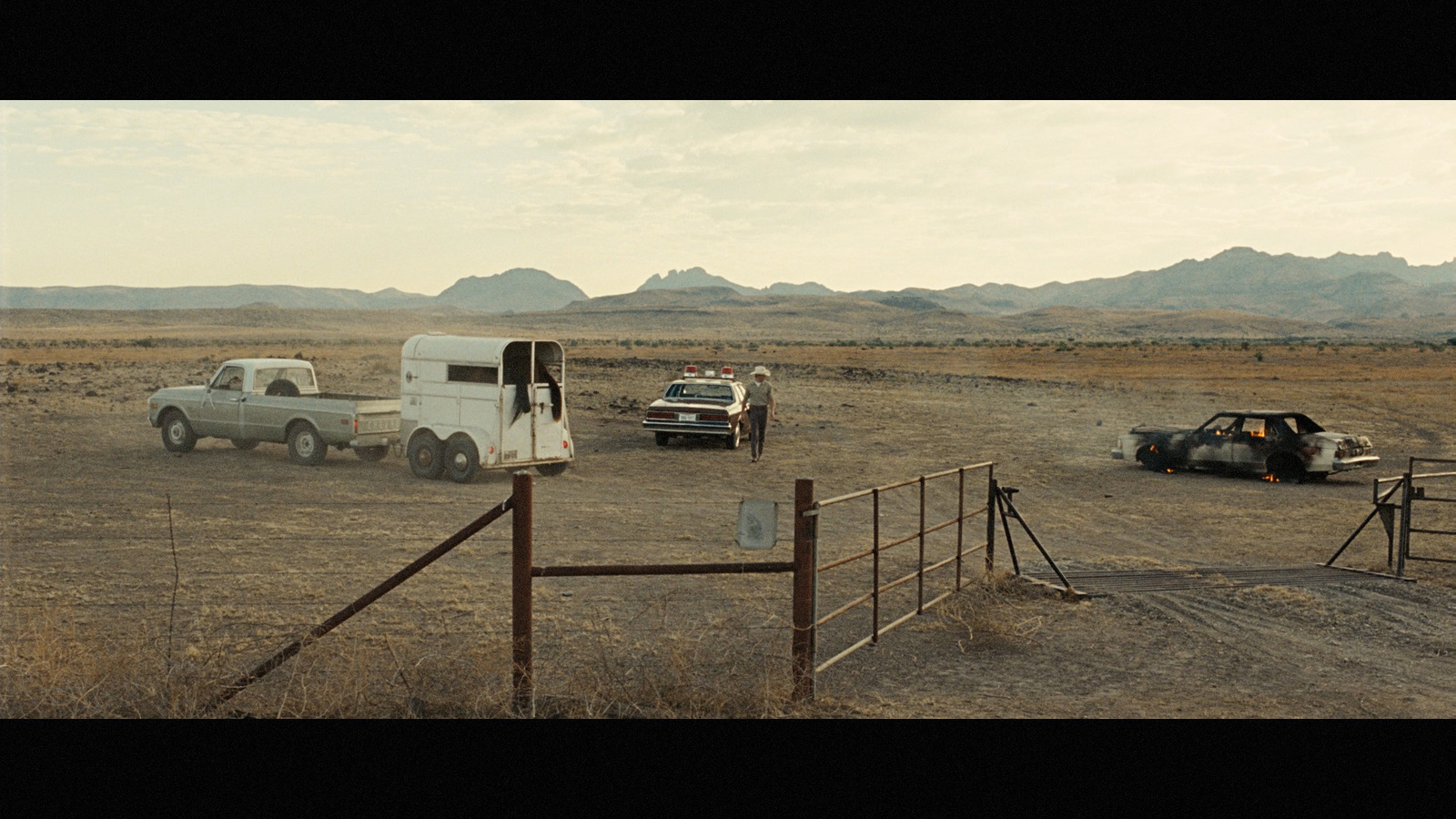 a couple of trucks that are sitting in the dirt