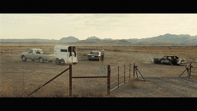 a couple of trucks that are sitting in the dirt