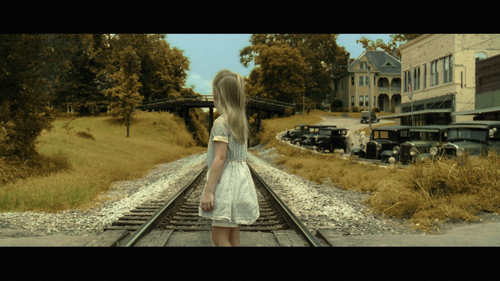 a woman is standing on a train track