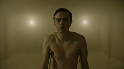 a shirtless man standing in a foggy room