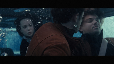 a group of people sitting in a car in the rain