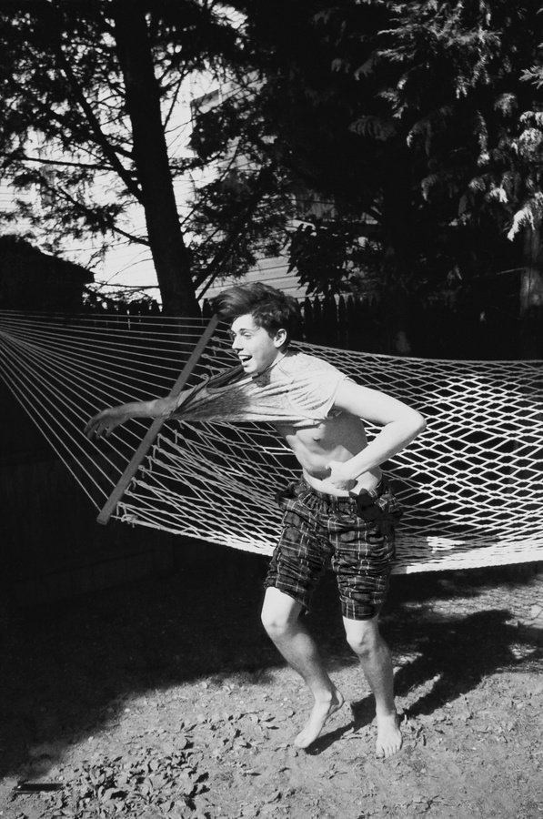 a man standing in front of a hammock