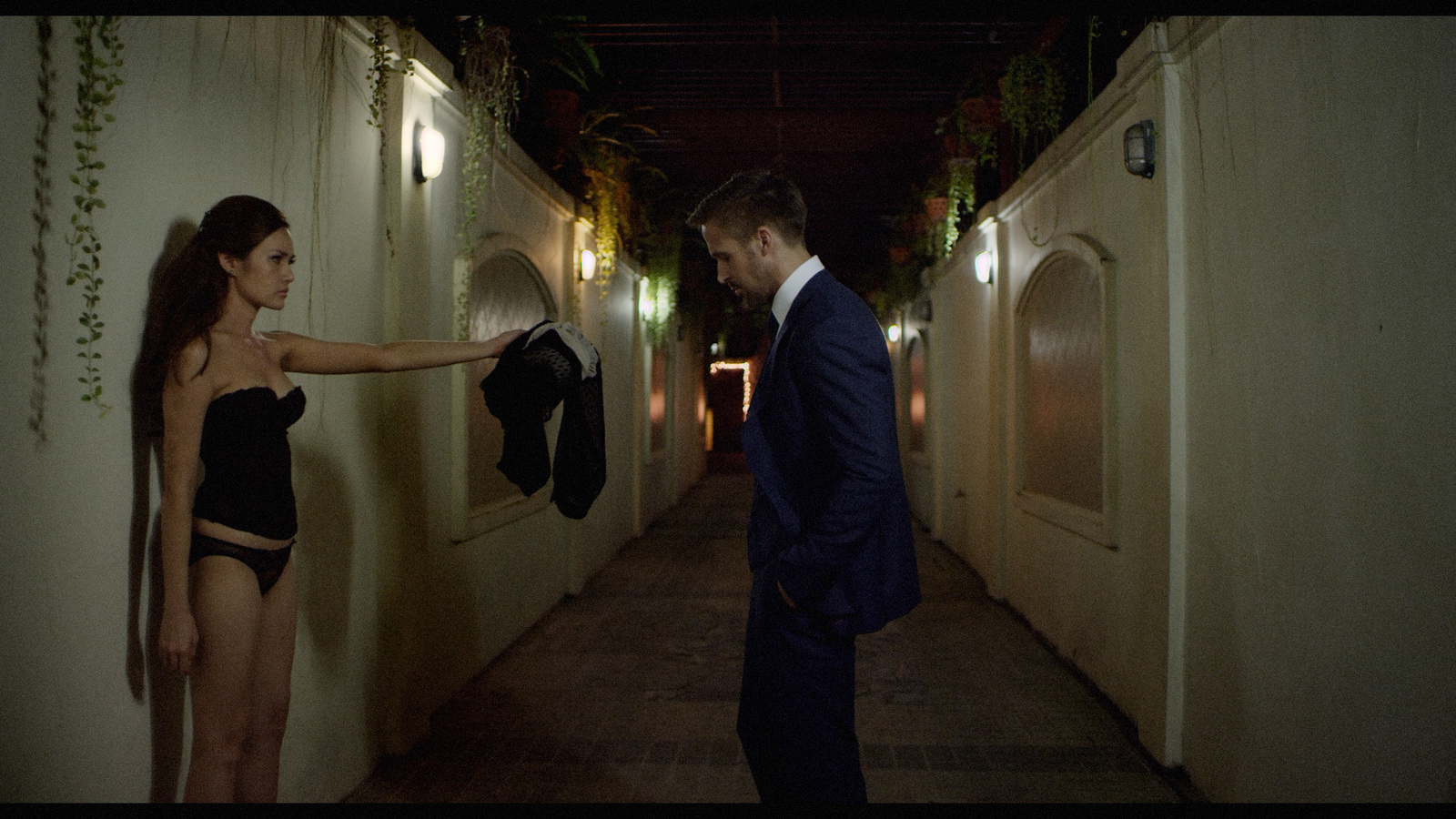 a man in a suit and a woman in a bathing suit