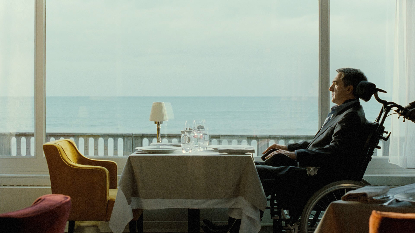 a man in a wheel chair sitting at a table