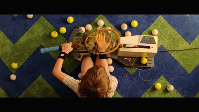 a person holding a tennis racquet on top of a tennis court