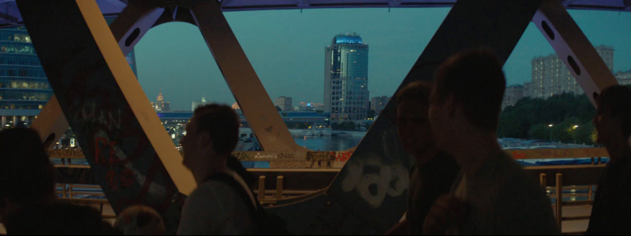 a group of people standing on top of a bridge