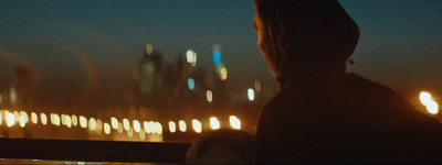 a person standing in front of a city at night