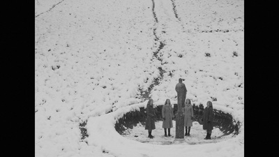 a black and white photo of a snow covered field