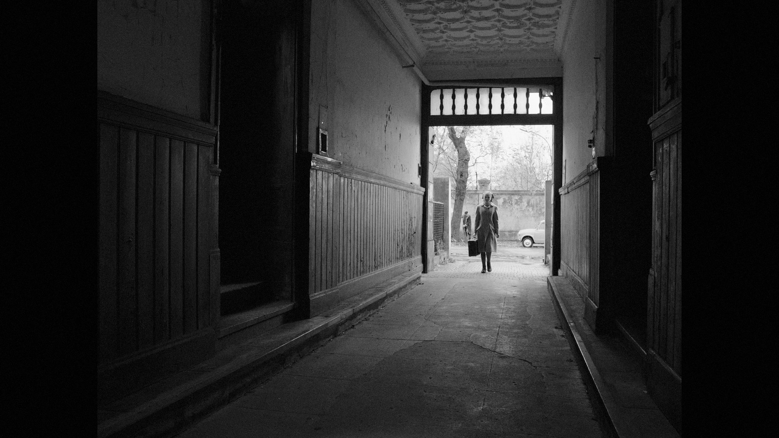 a person walking down a hallway in a building