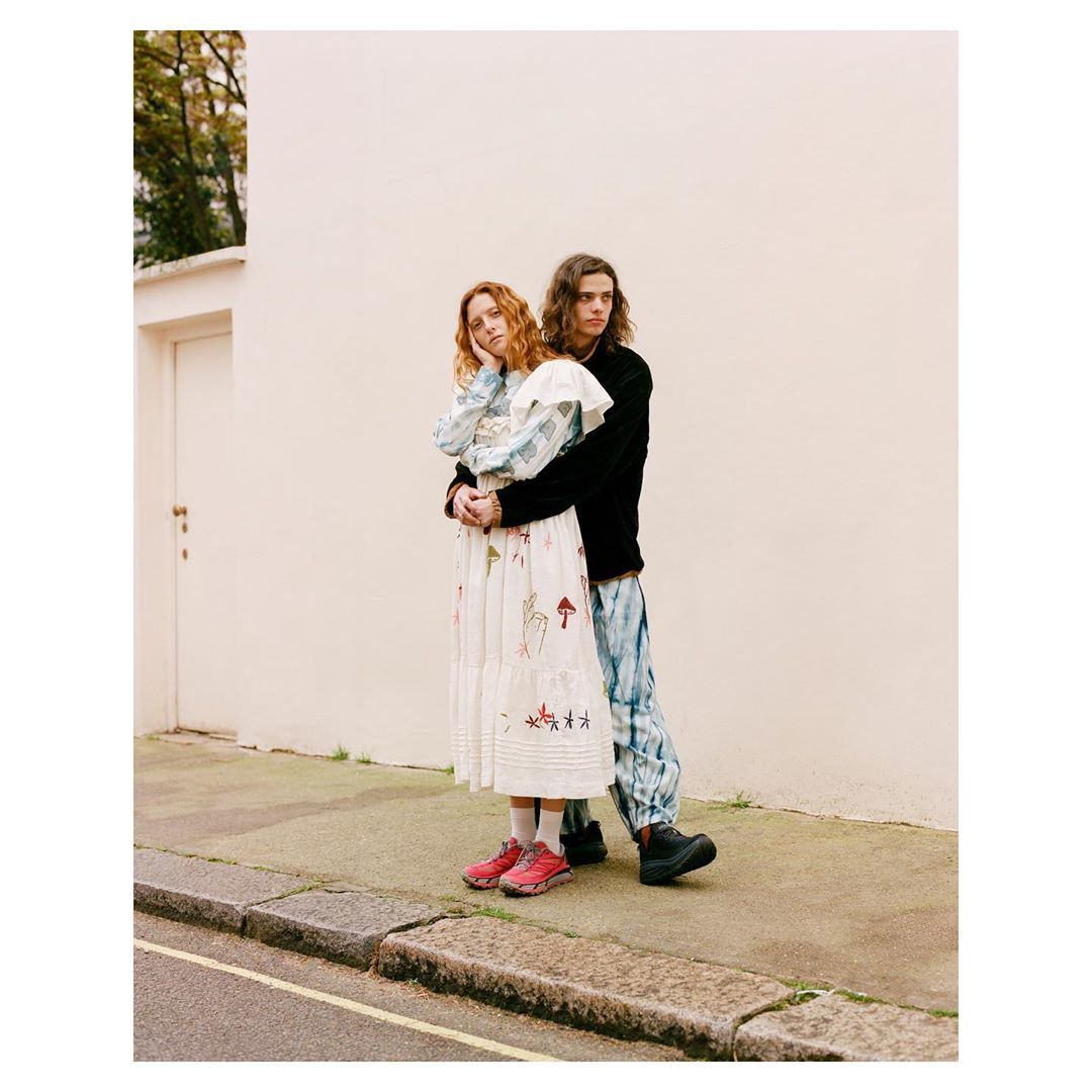 a man and a woman standing on a sidewalk