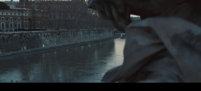 a statue of a woman standing next to a body of water