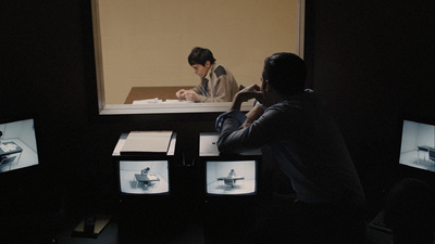 a couple of people sitting at a table in front of a tv